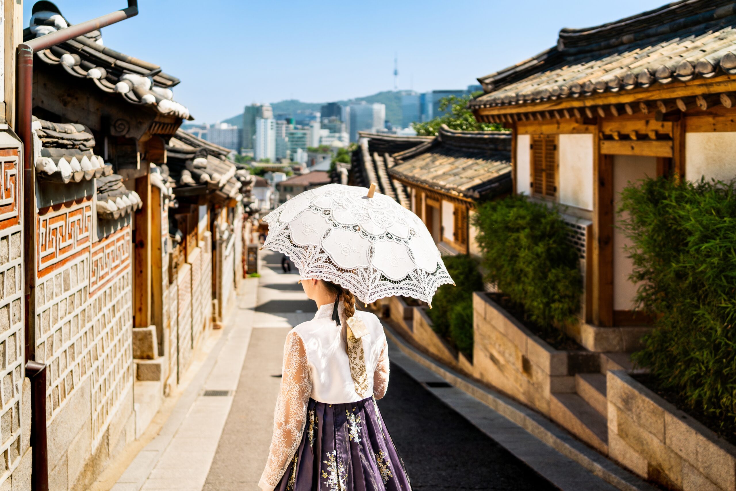 Woman Wearing Traditional Korean Hanbok Holding a White Lace Umbrella